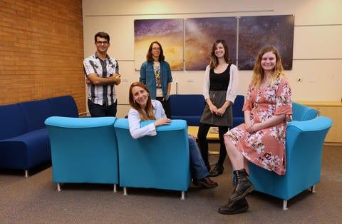 Dr. Laura Sales poses with her lab members